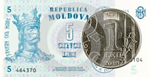 1 moldovan leu coin against 5 moldovan banknote indicating growing economics with copyspace