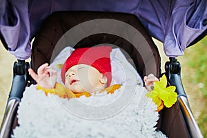 1 month old baby girl sleeping in perambulator