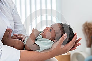 1-month-old baby newborn son, is lying on the mother's palm