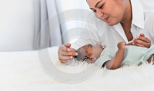 1-month-old baby newborn son, smile and looking at mother who is smiling and happy