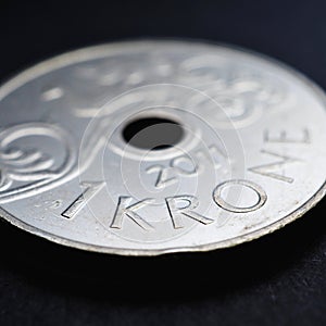 1 Norwegian krone coin close up. National currency of Norway. Money square illustration for news about economy or finance. Banking