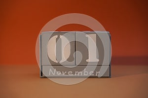 1 November on wooden grey cubes. Calendar cube date 01 November. Concept of date. Copy space for text. Educational cube