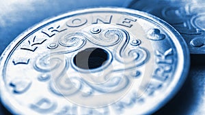 1 one Danish krone coin close up. National currency of Denmark. Blue tinted money illustration for news about economy or finance.