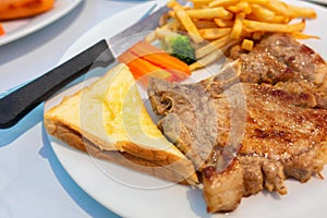 1 piece of fried meat with vegetables french fries and salad