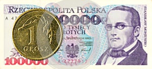 1 polish groszy coin against 100000 polish zloty bank note