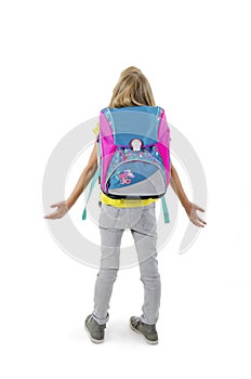 1-september concept. Back to school. Back view of little girl confusing. Shocked young girl with hands up. Full length.