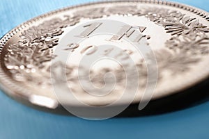 1 Swiss franc coin close-up. Illustration about the economy, business, money and finance of Switzerland. Central bank, banking