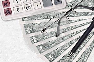 1 US dollar bills fan and calculator with glasses and pen. Business loan or tax payment season concept