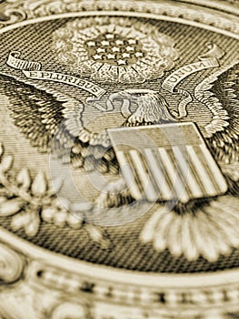 1 US dollar. Fragment of banknote. Reverse of bill with the Great Seal. The bald eagle is the national symbol. Olive tinted