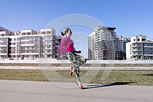 1 white chubby young woman running down the street on the background of buildings in the city, runner, sport