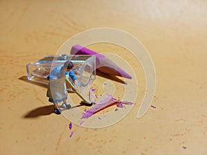 1 woman cleaning trash from pencil sharpener with negative space