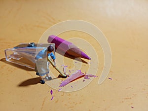 1 woman cleaning trash from pencil sharpener with negative space