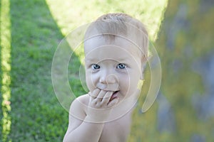 1 year baby boy playing hide-and-seek on swimming pool grass