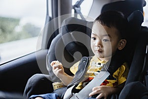 1 Year Old Adorable Asian Boy Alone Looking Around From Car Seat in the Car