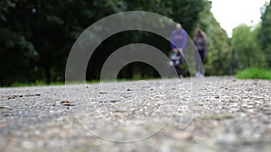 1 Young couple walking with carriage in park. Defocus
