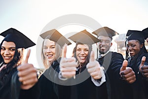 1. Your time as a caterpillar has expired. Your wings are ready.Portrait of a group of students showing thumbs up on