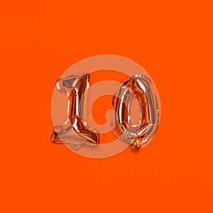 10,000 followers numbers foil balloons on an orange background. Blogger blogging followers concept