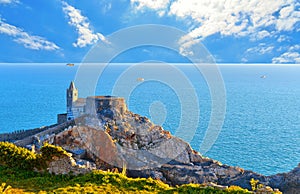 10.04.2017. San Pietro church, Lord Byron Natural park in Portovenere village on stone cliff rock and blue sky, view f