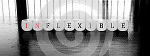 10 dices forming the Words `inflexible` or `flexible` dilema concept
