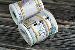 10 EGP LE ten Egyptian pounds cash money bills rolled up with rubber bands with a image of Al Rifa'i the royal mosque