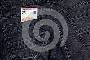 10 euros coming out of the jeans pocket