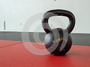 10 kg kettle bell sitting on gym mat with space to left