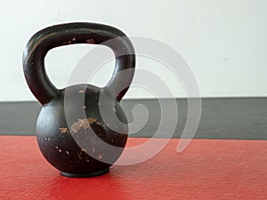 10 kg kettle bell sitting on gym mat with space to right