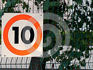 10 kmh speed limit 10mph car kph road sign panel on street city on the town road