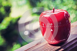 10 Minute Kitchen Egg Timer in Apple Shape Standing On A Handrail