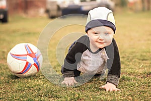 A 10 month old Caucasian boy with a soccer ball