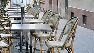 10 October 2021 - Strasbourg, France: Deserted empty cafe tables by which passers-by pass