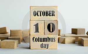 10 October - Columbus day is written on wooden cubes stacked in the form of a mobile calendar