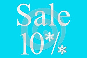 10 percent sale on a blue background, top view. Background for Christmas, new year, and winter sales. Seasonal discounts in stores