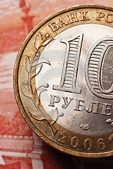 A 10-ruble bimetallic Russian coin hangs above a 5000 note. Banks, microfinance and microcredit organizations. Loans, deposits,