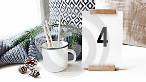 10 second countdown. Calendar, pine cones and mug with pencils standing on white table in cozy home, office. Passing