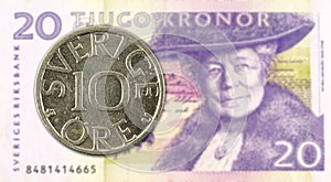 10 swedish oere coin against 20 swedish krona bank note