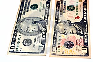 10 ten dollars bill banknotes with portrait of Secretary Alexander Hamilton on obverse side and U.S. treasury building on reverse