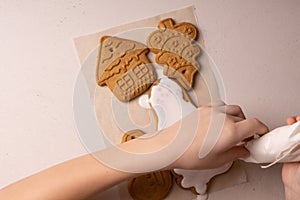 A 10-year-old boy glazes cookies with a culinary bag. Handmade. Children& x27;s creativity