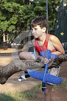 10 year old Brazilian child playing with his Styrofoam plane on a sunny afternoon_14