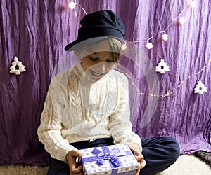 A 10-year-old European boy receives and enjoys a Christmas present