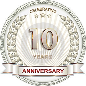 10 years anniversary logo design with laurel wreath in circle on rays background with stars. Vector illustration