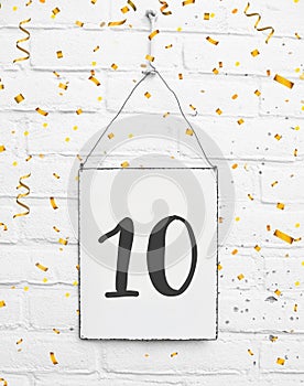 10 years old birthday party card with number ten with golden confetti