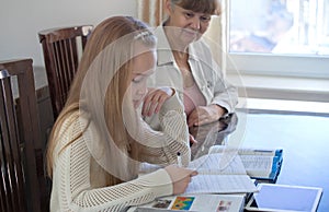 10 years old girl and her teacher. Little girl study during her private lesson. Tutorial and educational concept.