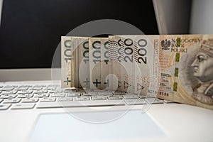 100 200 Polish PLN cash on laptop computer, make money or buy online