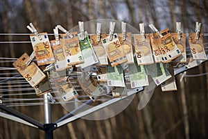 100 and 50 euro banknotes drying. Washed Euro paper bills. Drying euro on a string
