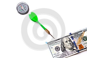 100 american dollars on a white background and compass, to make correct and accurate investment