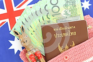 100 Australian green cash money with Thai passport on Australian flag background.