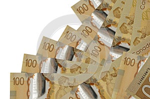 100 Canadian dollars bills lies in different order isolated on white. Local banking or money making concept
