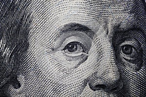 100 Dolar USA close up. Franklin eyes macro. The texture of the fragment of the dollar bill. USD banknote texture. One hundred Ame