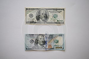 100 dollar bill on a white background. Pile of new and old one hundred dollar bill